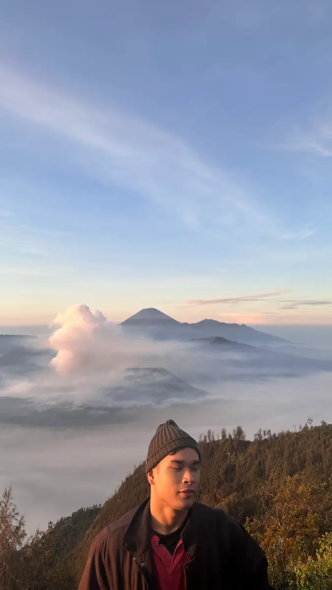 Standing above the clouds at Mount Bromo at sunrise